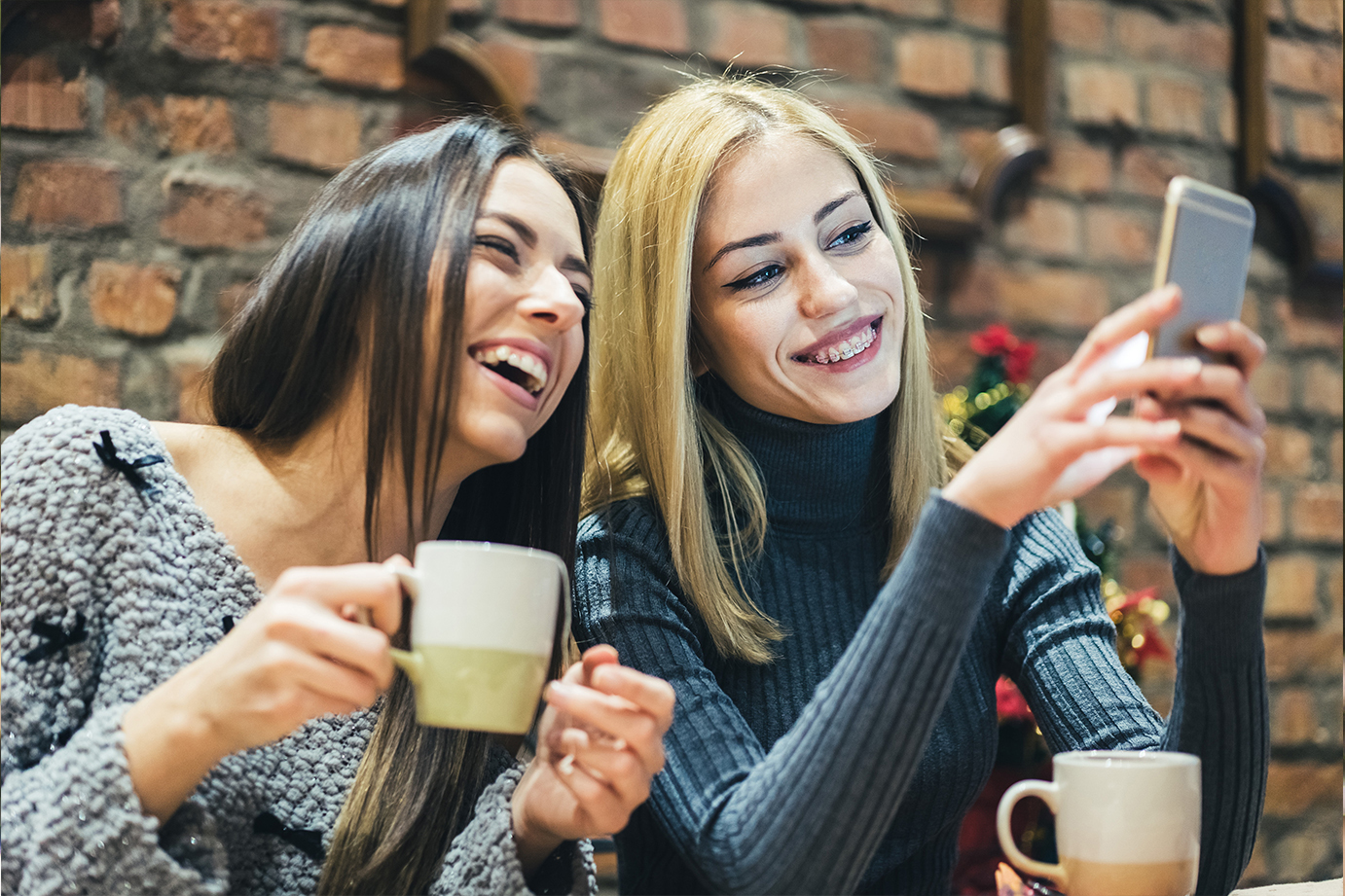 2 women with braces having coffee